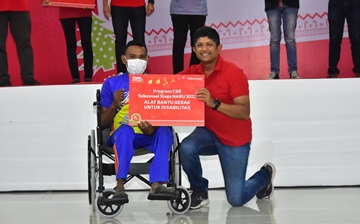 Direktur IT Telkomsel Bharat Alva (kanan) secara simbolis beri bantuan ke penyandang disabilitas saat Roadshow Natal 2022 di Ambon (foto/ist)